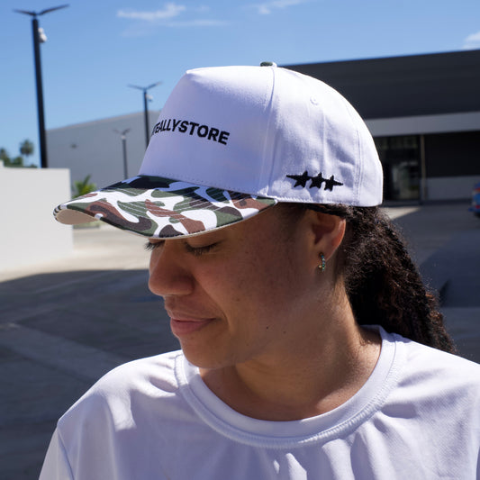 Person wearing a white cap with 'Kastore' branding outdoors.