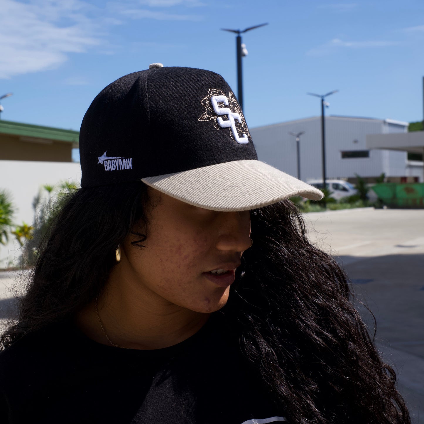 Person wearing a cap with a clear blue sky in the background